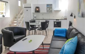 a living room with a couch and a table at 2 Bedroom Stunning Apartment In Allinge in Allinge