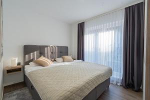 a bedroom with a large bed with a large window at Toni in Krapina +29 photos