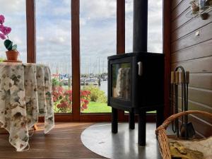 a fireplace in a living room with a window at Chalet Christine mit kleinem Garten in Anjum +14 photos