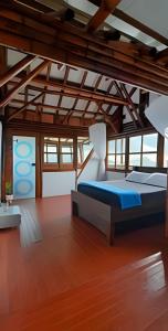 a bedroom with a bed in a room with wooden floors at Club Cean in Madroñal