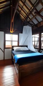 a bedroom with a bed in a room with windows at Club Cean in Madroñal