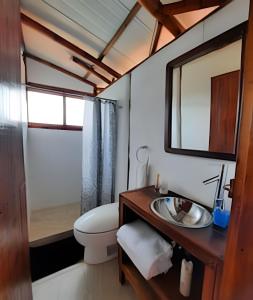 a bathroom with a toilet and a sink and a mirror at Club Cean in Madroñal +61 photos