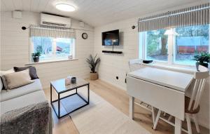 a living room with a piano and a couch at Lovely Home In Ludvigsborg With Kitchen in Hörby
