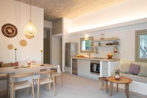 a kitchen and living room with a table and chairs at Themis Homes in Skiros