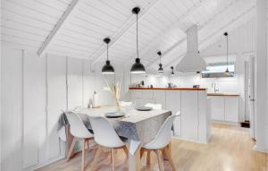 a kitchen and dining room with a table and chairs at Three-Bedroom Holiday Home In Oksbol in Oksbøl