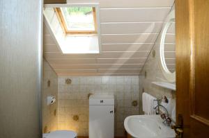 a bathroom with a sink and a skylight at Residence Granvara in Ortisei +37 photos