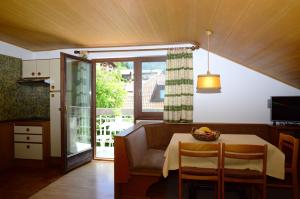 a kitchen with a table with a bowl of fruit on it at Residence Granvara in Ortisei