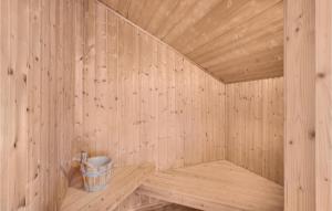 a wooden sauna with a bucket in it at Pet Friendly Home In Hvide Sande in Bjerregård
