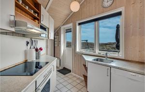 a kitchen with a sink and a window at Pet Friendly Home In Hvide Sande in Bjerregård