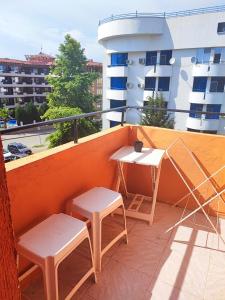 a balcony with two tables and chairs on a building at Fa Mol in Sunny Beach +44 photos