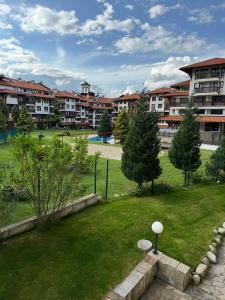 a view of a park with buildings in the background at Cedar Lodge III One BDRM Flat B2 in Bansko
