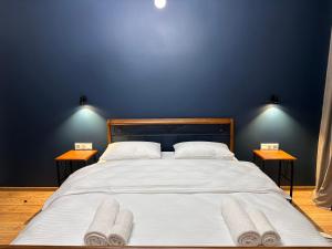 A bed or beds in a room at Hotel Mountime Kazbegi