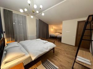 A bed or beds in a room at Hotel Mountime Kazbegi