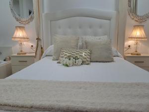 Łóżko lub łóżka w pokoju w obiekcie Apartamento Romero Garden B