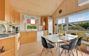 a kitchen with a white table and chairs at Two-Bedroom Holiday Home In Hemmet in Hemmet
