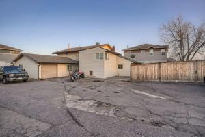 a house with a motorcycle parked in a driveway at 1,000 Per Month Rebate When Buying A Home in Lakewood