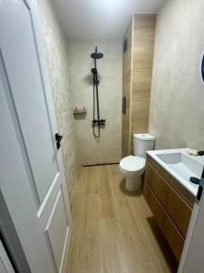 a bathroom with a toilet and a sink and a shower at South Beach Apartment Primorsko in Primorsko