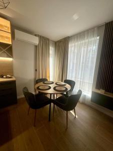 a dining room with a table and chairs in a room at South Beach Apartment Primorsko in Primorsko