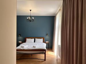 A bed or beds in a room at Hotel Mountime Kazbegi