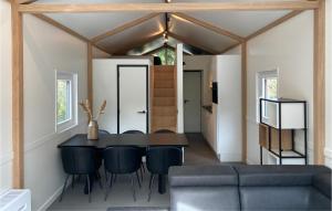 a dining room with a black table and chairs at Awesome Home In Putten With Wifi in Putten