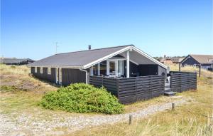 a black house on the side of a beach at Holiday Home Arvidvej Iv in Bjerregård