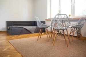 a living room with three chairs and a couch at Apartament Słoneczny Rabka Zdrój in Rabka-Zdroj +8 photos