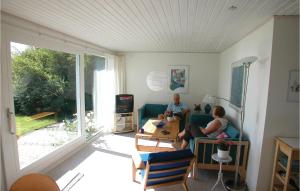 two people sitting on a couch in a living room at Mindegården in Hejls