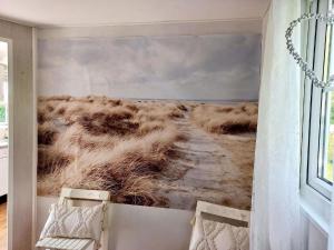 a room with a painting of a field at Gemütliches Chalet mit Terrasse in Baarland +13 photos