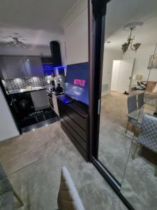a view of a kitchen and a living room at Stylish London Apartment & Free Parking in London +23 photos
