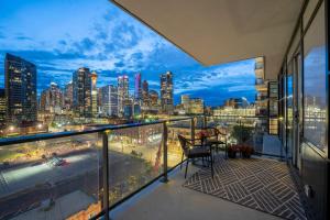 a balcony with a view of a city skyline at "The Draper" - Luxury Corner Unit w Tower View, - Near Stampede, Saddledome, BMO Centre! FREE Parking, Banff Pass, & Wine! in Calgary