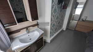 a bathroom with a sink and a shower at Martell's Hotel in Blackpool