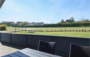 a patio with two chairs and a view of a park at Holiday Home Skovløkken Hejls Vi in Hejls +15 photos