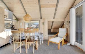a dining room with a table and chairs at Holiday Home Skovløkken Hejls Vi in Hejls