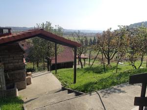 a patio with a pavilion in a yard with trees at Holiday Home Dora in Zabok