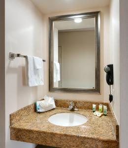 a bathroom with a sink and a mirror at Cortona Inn and Suites Anaheim Resort in Anaheim