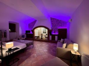 a purple room with a bed and a couch at Villa Egle in Cenerente +47 photos