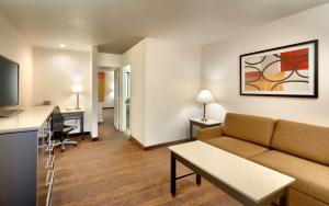 a living room with a couch and a table at Cortona Inn and Suites Anaheim Resort in Anaheim