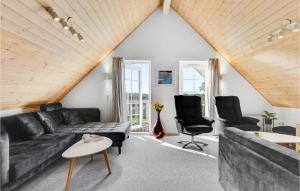 a living room with a black couch and two chairs at Lovely Home In Gråsten With Wifi in Gråsten