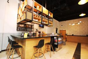 a bar in a restaurant with black stools at Hotel Blue Paradise inn in Turbo