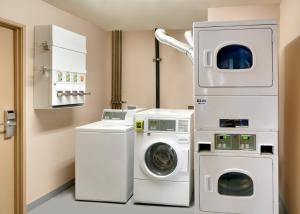 a laundry room with a washer and dryer at Cortona Inn and Suites Anaheim Resort in Anaheim