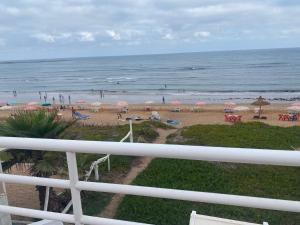 a view of a beach with umbrellas and the ocean at Maison d'hôte sur la Plage de Bouznika in Bouznika +8 photos