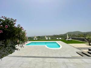 a swimming pool in the middle of a landscaped yard at Maison Divaga in Fleri