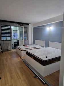 two beds sitting in a room with ainylinylinyl at EVA Studio Eforie Nord in Eforie Nord