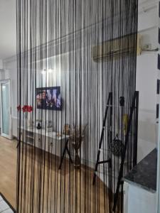 a living room with a large wall of curtains at EVA Studio Eforie Nord in Eforie Nord