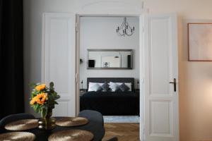 a bedroom with a bed and a table with a vase of flowers at Apartment Dusni Superior in Prague