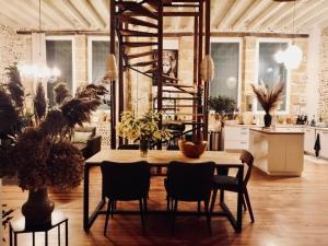a dining room with a table and some plants at Chambre dans ancienne ecole in Cazères-sur-lʼAdour