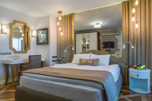 
a bedroom with a large bed and a large mirror at Izmir Palas Hotel in İzmir
