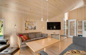 a living room with a couch and a table at Holiday Home Dyssebjergvej Rømø Denm in Rømø Kirkeby