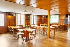 a dining room with wooden tables and chairs at Pilgerhaus Maria-Rickenbach - Anreise nur via Luftseilbahn möglich in Dallenwil