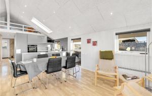 a kitchen and dining room with a table and chairs at 4 Bedroom Amazing Home In Hvide Sande in Bjerregård